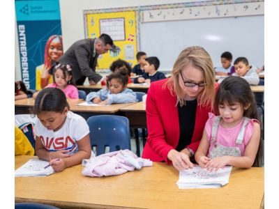 Volunteers working with elementary aged students in a typical classroom
