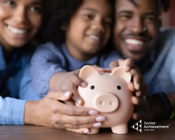 Family holding a piggy bank